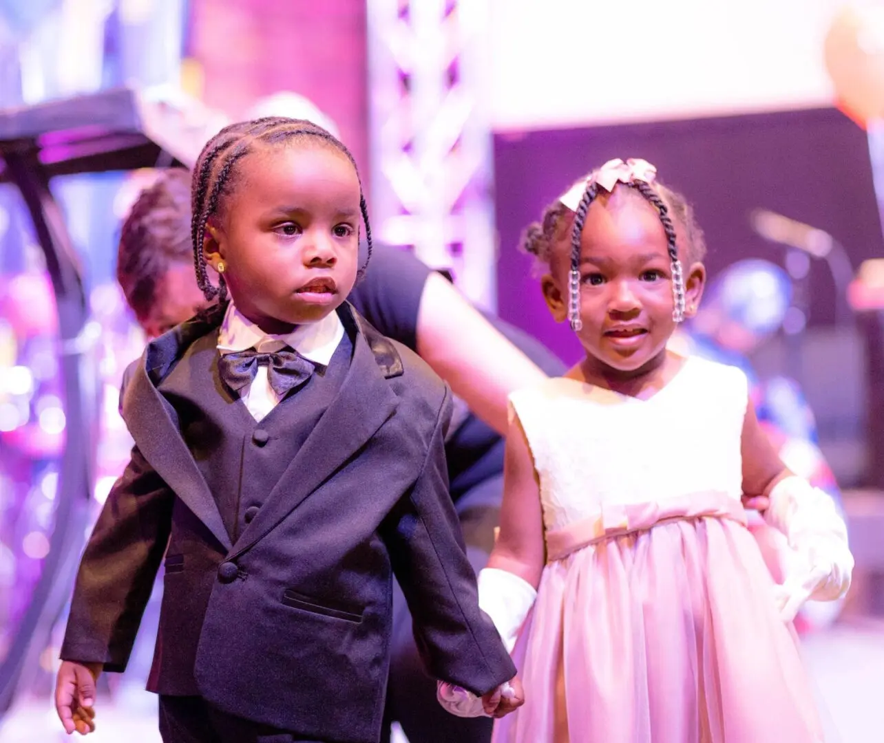 Two children dressed for a formal event.