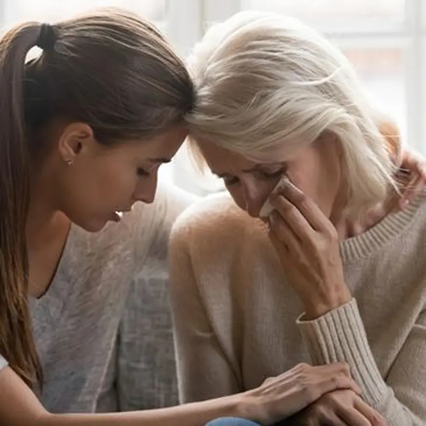 Woman comforting another woman, emotional support.
