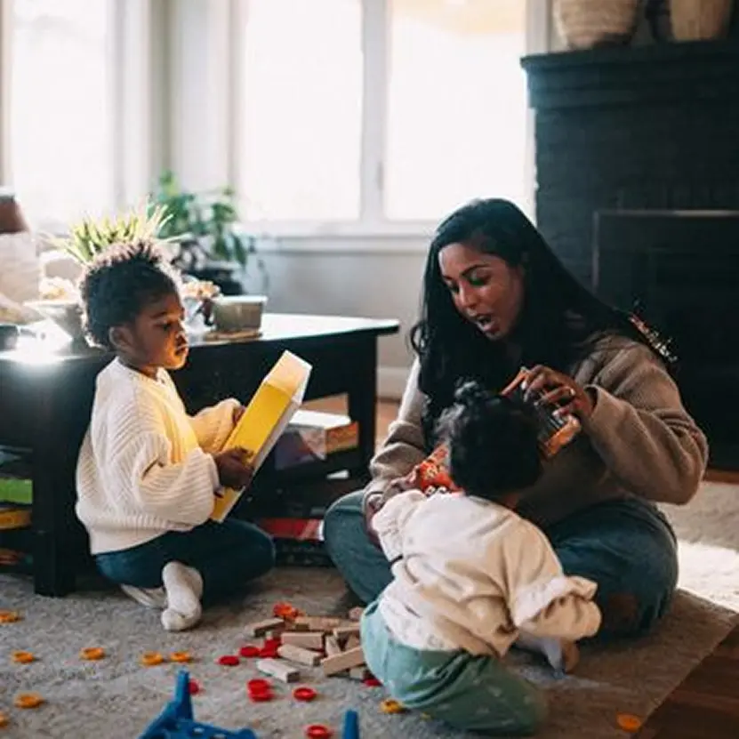 Family playing with toys in living room.
